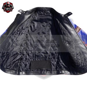 May include: Black leather motorcycle jacket with a quilted black lining. The jacket has a blue and red design on the sleeves and shoulders. The interior features a pocket and the brand logo.