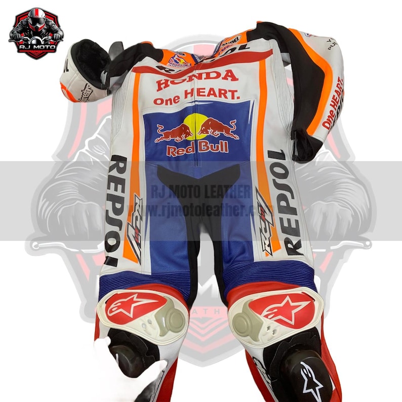 May include: A white, blue, and orange motorcycle racing suit with "HONDA one HEART" and logos. The suit features "REPSOL" branding and a star design on the knee pads. The suit is made of leather and has black accents.