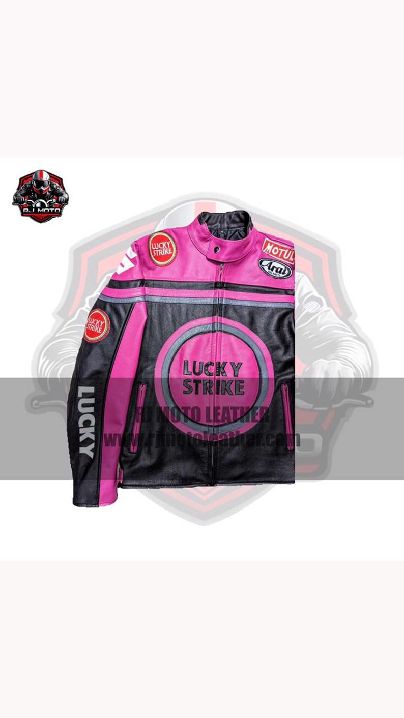 May include: A black and pink leather motorcycle jacket with the "Lucky Strike" logo. The jacket has a zip-up front, various patches, and the website address "www.tr4motoleather.com".