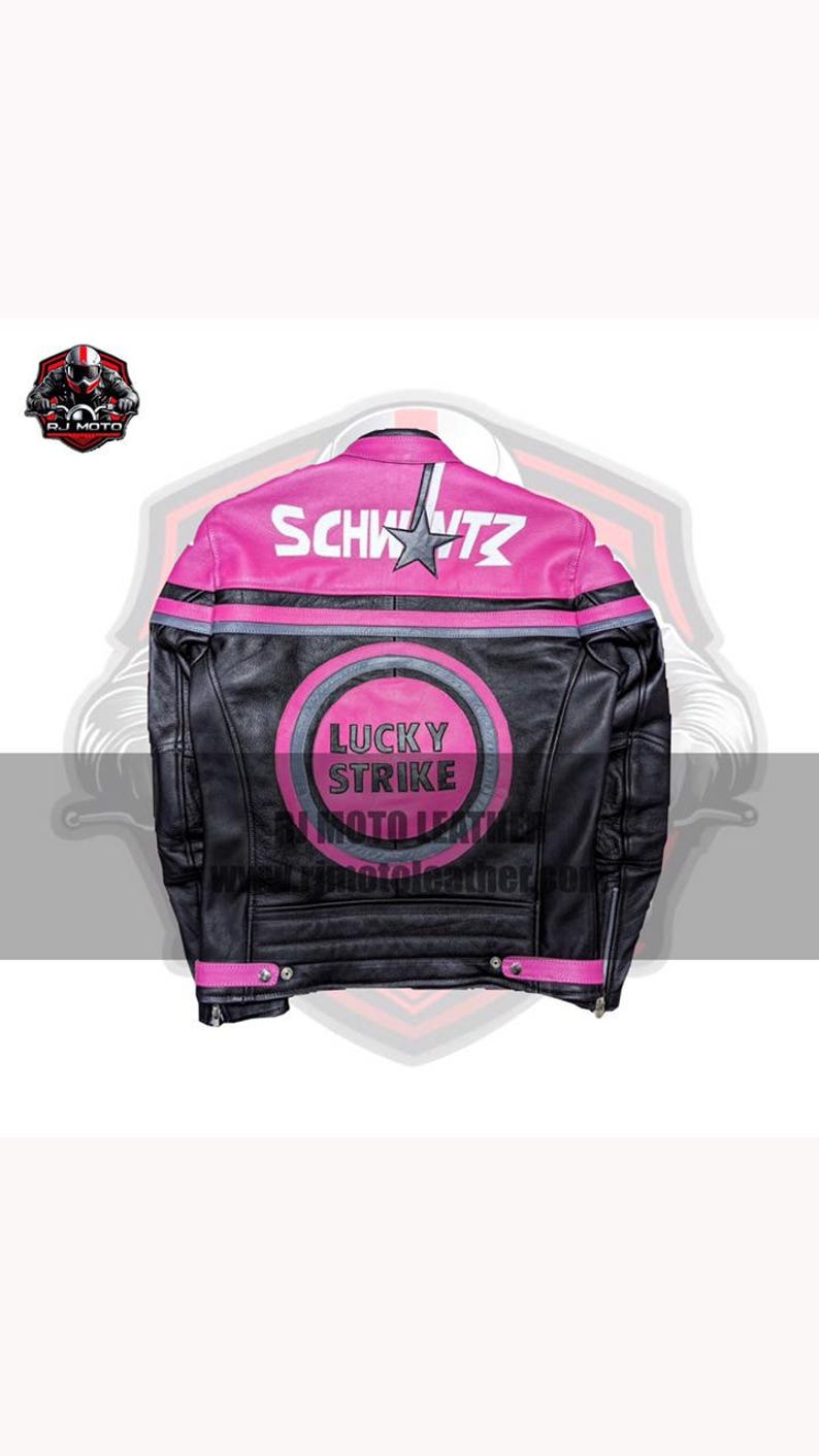 May include: Black leather motorcycle jacket with pink detailing. The back displays the word "SCHWITZ" above a star, and a "LUCKY STRIKE MOTO LEATHER" logo. The jacket has a classic biker style with a zip closure and snap details.