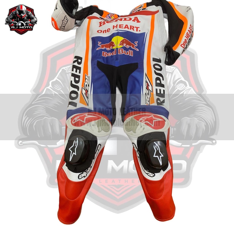 May include: A white, blue, and red motorcycle racing suit with "Honda, and "Repsol" logos. The suit has black knee sliders and orange accents. The suit is designed for protection and speed.