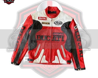 May include: A red, white, and black leather motorcycle jacket with the Ducati logo. The jacket features the logos of Motul, Michelin, and Arai. The sleeves have the word "Ducati" printed vertically. The jacket has a zip closure and a buckle at the waist.