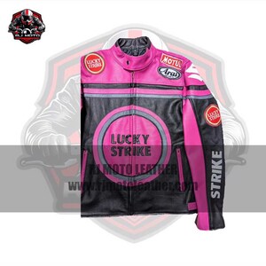May include: Black and pink leather motorcycle jacket with "LUCKY STRIKE" and "STRIKE" text. Features a round emblem on the chest and patches on the sleeves. The jacket has a zipper closure and a stand-up collar.