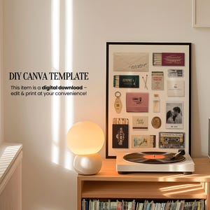 May include: A framed collage of vintage matchboxes, photos, and other ephemera. The collage is in a black frame and is hanging on a white wall. A lamp and a record player are on a wooden shelf below the collage.