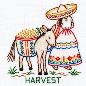 May include: A colorful embroidery design on white fabric featuring a person wearing a wide-brimmed sombrero and a long dress, standing beside a donkey carrying a basket filled with yellow produce. The word HARVEST is stitched in green below.