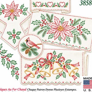 May include: A set of white fabric pieces featuring embroidered Christmas designs including a red poinsettia, a cardinal on a pine branch, and gold bells with red ribbons. The number 3858 is printed in the top right corner of the image.