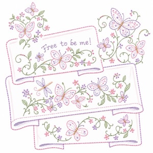 May include: An embroidery design featuring three white fabric banners decorated with purple and pink butterflies, green vines, and small flowers. The top banner includes the embroidered text "Free to be me!" in a purple script font.