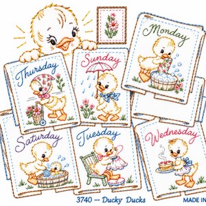 May include: A set of seven embroidered fabric squares featuring yellow ducklings performing daily activities labelled with the days of the week. Each square includes colourful thread work, a small flower motif, and the text 3740 - Ducky Ducks.