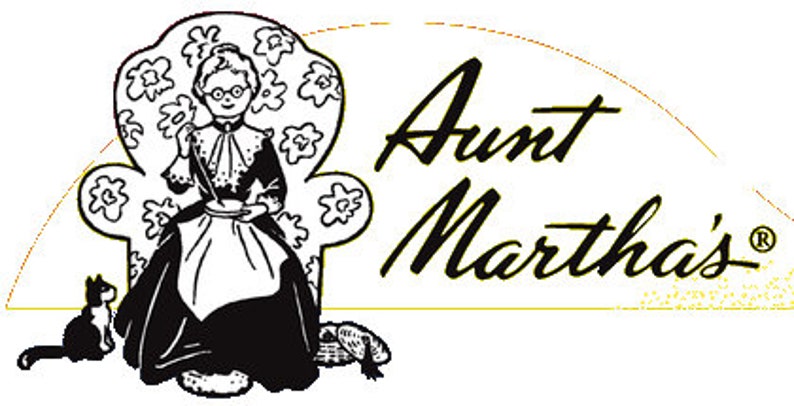 May include: Black and white illustration of a woman sitting in a chair with a cat beside her. The text "Aunt Martha's" is written in a cursive font.