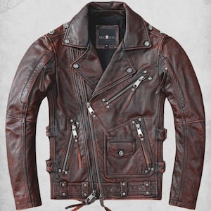May include: A brown leather biker jacket featuring multiple silver zippers, pockets, and snap details. The jacket has an asymmetrical design with a notched collar. The text "Negan Biker Leather Jacket" is at the top.