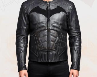 May include: Black leather jacket with a Batman logo on the chest. The jacket has a zip-up front, a round collar, and quilted detailing on the torso. The sleeves have zippers at the cuffs.