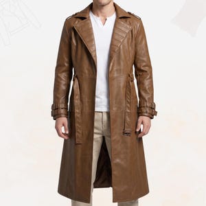 May include: A long brown trench coat featuring a wide lapel with horizontal stitching, a waist belt with a buckle, and adjustable buckled straps on the cuffs. The coat is worn over a white V-neck shirt and light-colored trousers.