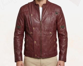 May include: A burgundy leather jacket with a stand-up collar, a front zipper, and multiple decorative gold-colored buttons. The jacket has a perforated design on the upper chest and shoulder details.