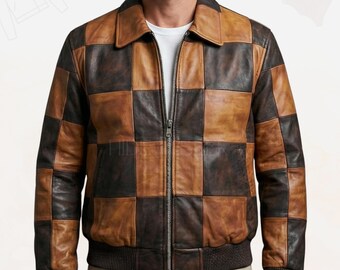 May include: A brown and black checkered leather jacket with a zipper closure. The jacket has a collared neckline and ribbed cuffs and hem. The jacket appears to be made of high-quality leather.