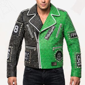 May include: A two-tone black and green leather jacket with silver studs and white trim. The jacket features multiple patches with text and symbols, and has a zipper closure. The sleeves have the number "8" and "6" on them.