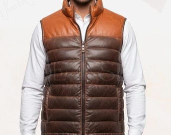 May include: A brown and tan leather vest with a high collar and a full-length zipper. The vest is quilted with horizontal stitching and is worn over a white dress shirt. The vest has a classic, rugged look.