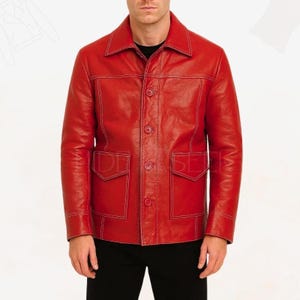 May include: A red leather jacket with white stitching details. The jacket has a collared neckline, button-up front, two chest pockets, and two lower pockets. The sleeves are long, and the jacket appears to be a medium weight.