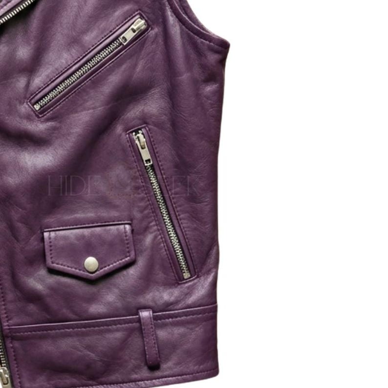 May include: Close-up of a purple leather jacket with silver zippers and a small pocket. The jacket has a classic biker style with a notched collar and a fitted silhouette. The text "HIDE" and "WER" is visible on the jacket.
