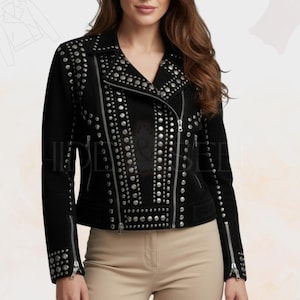 May include: Black suede jacket adorned with silver studs. The jacket has an asymmetrical zip, notched lapels, and zipped cuffs. The studs are arranged in rows and clusters, giving the outerwear a bold, edgy look. A stylish piece of clothing.