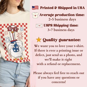 May include: Cream-colored t-shirt featuring a cartoon goose holding a firework container with stars and stripes. The goose wears star-shaped glasses, set against a red and white checkered background. The text on the shirt reads "Printed & Shipped in USA".