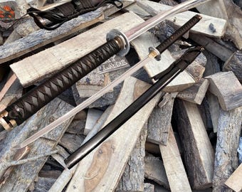 May include: Two Japanese-style swords with black and brown handles and silver blades are displayed against a backdrop of stacked wood. One sword is sheathed in a black scabbard. The handles have intricate woven patterns.