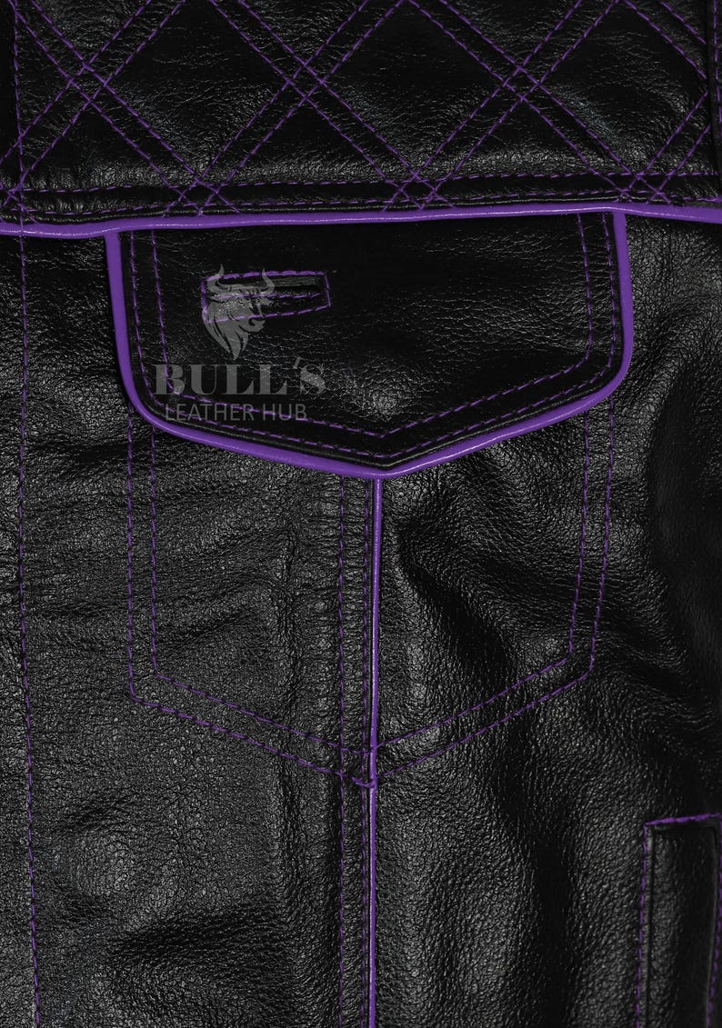 May include: Close-up of a black leather jacket with purple stitching and trim. The jacket features a pocket with the text "BULL'S LEATHER HUB" and a bull logo. The stitching creates a diamond pattern on the upper back.