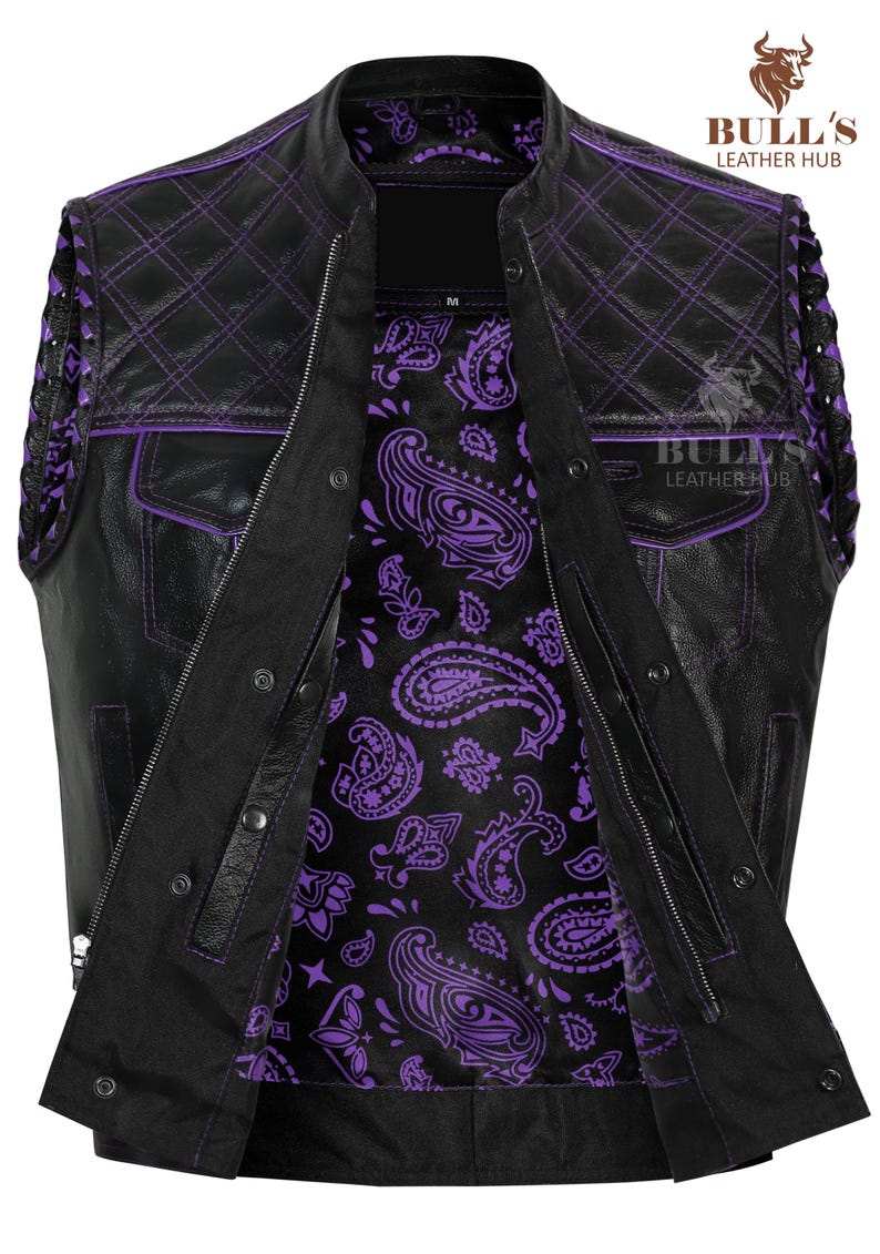 May include: Black leather vest with purple stitching and a paisley interior. The vest features a quilted design on the shoulders and pockets. The vest has a zipper closure and snap buttons. The Bull's Leather Hub logo is visible in the upper right corner.