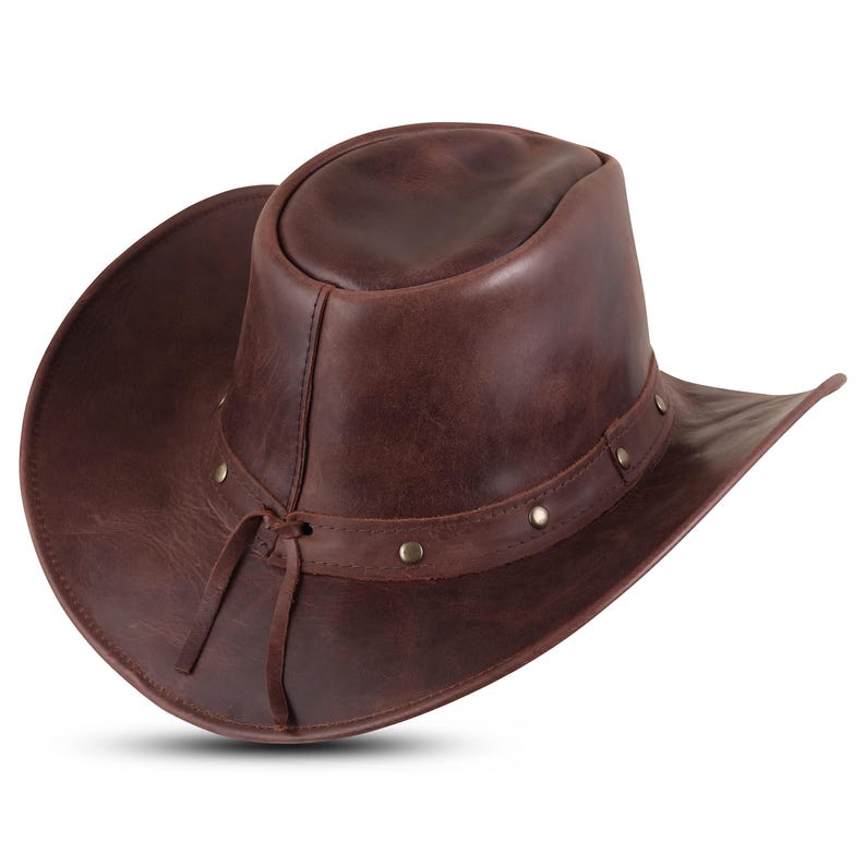 May include: A brown leather cowboy hat with a wide brim and a braided leather band. The hat has a distressed look and is decorated with metal studs.