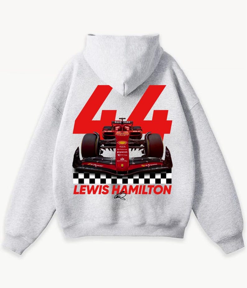 May include: A light gray hoodie featuring a red Formula 1 race car graphic. The number "44" is displayed in large red numerals above the car, with "LEWIS HAMILTON" printed below the car in red. A black and white checkered pattern is at the bottom.
