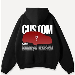 May include: Black hoodie with the word "CUSTOM" in white block letters across the back, above a red car silhouette with a question mark. The word "CAR" is below the car graphic, with text describing car features.