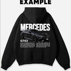 May include: Black hoodie featuring a graphic of a black Mercedes GT63 car. The word "MERCEDES" is printed in white across the back, with "GT63" below the car image. The word "EXAMPLE" is printed at the top.