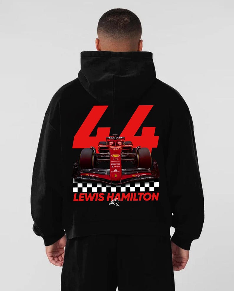 May include: Black hoodie featuring a red Formula 1 race car graphic. The number "44" is prominently displayed in red, along with the text "LEWIS HAMILTON" and a checkered flag design. The hoodie is a comfortable, casual style.