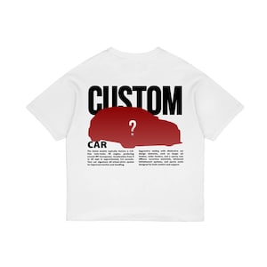 May include: White t-shirt with the word "CUSTOM" in large black letters above a red car silhouette with a question mark. Below the car graphic, the word "CAR" is printed in black. The shirt has short sleeves.