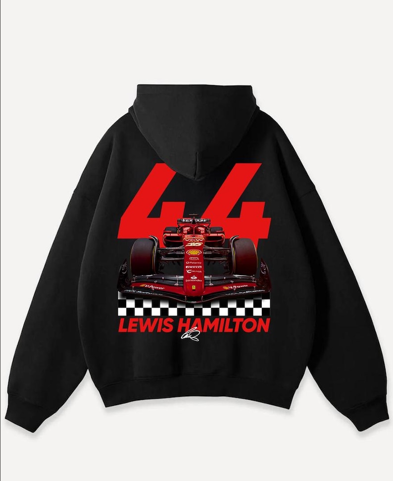 May include: Black hooded sweatshirt featuring a Formula 1 race car graphic. The design includes the number 44 in red, a checkered flag pattern, and the text "LEWIS HAMILTON". The car is red and black.