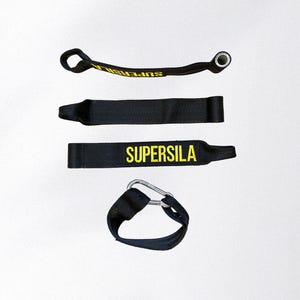 May include: Four black exercise straps with yellow text reading "SUPERSILA". The straps include a loop, a metal carabiner, and a metal eyelet. The straps are designed for fitness and strength training.