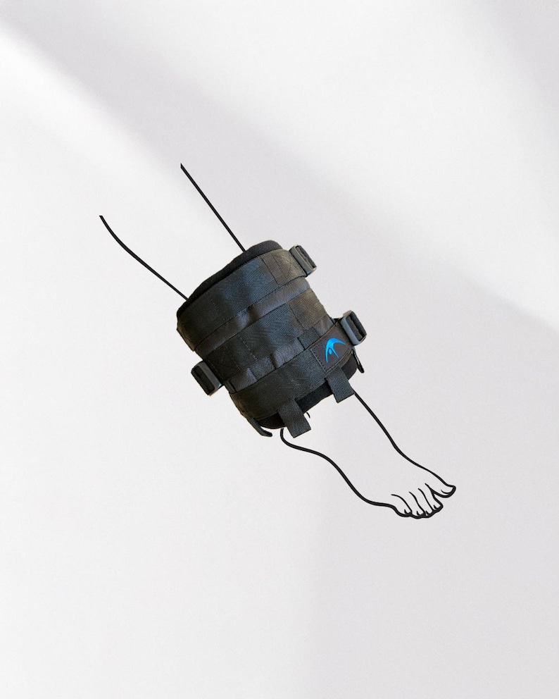 May include: Black ankle brace with multiple straps and buckles, featuring a blue logo. The brace is attached to a line drawing of a foot. The background is plain white.