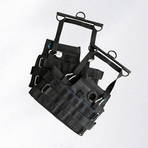 May include: Black exercise equipment with multiple straps, metal rings, and a blue accent. The equipment appears to be designed for suspension training or similar fitness activities. The design includes adjustable straps and metal hardware.