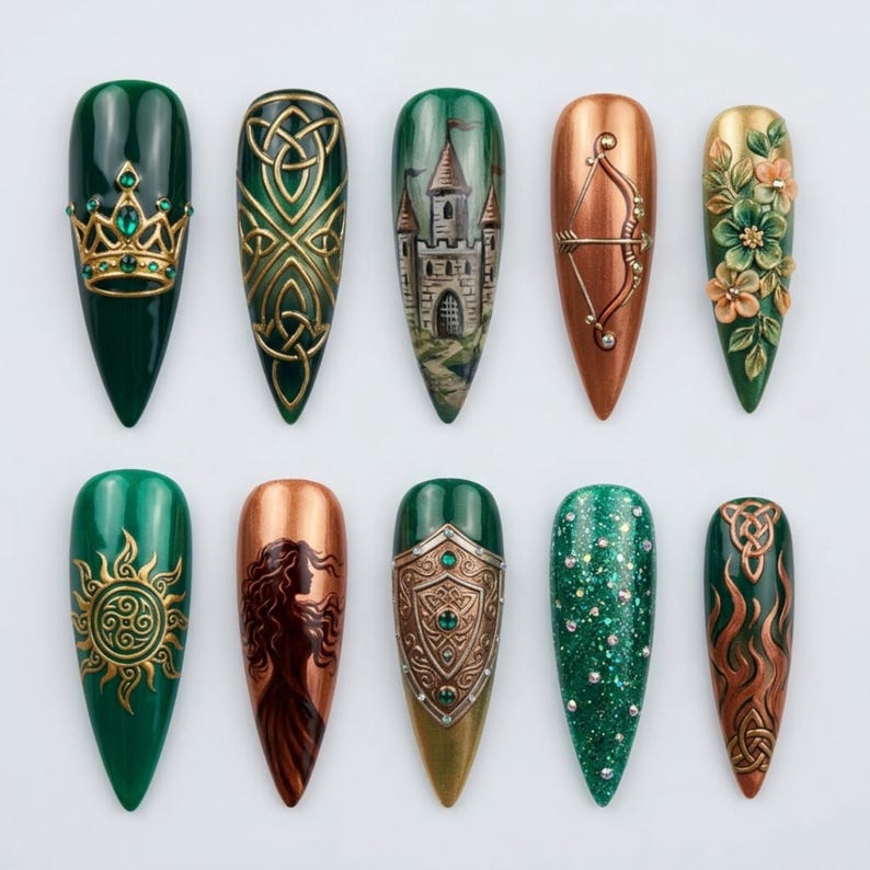 May include: A collection of ten long, pointed artificial nails. Each nail features unique designs, including a crown, Celtic knots, a castle, a bow and arrow, flowers, a sun, a woman's silhouette, a shield, glitter, and more Celtic knots. The color palette includes green, gold, and copper.