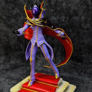 Pu&ograve; includere: Statuetta dettagliata di un personaggio in un completo viola e oro con un mantello rosso. La figura &egrave; su una base a pi&ugrave; livelli con un tappeto rosso. Il personaggio ha un elmo con una visiera viola.