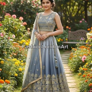 May include: A sleeveless, gray and gold embroidered lehenga with a matching dupatta. The lehenga features intricate gold floral patterns and a detailed bodice. The text "FashionLondonArt" is visible.