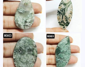 May include: Four moss agate gemstones in various shapes: teardrop, oval, and leaf-like. The stones display a mix of translucent white, gray, and green patterns, resembling moss. Each stone is held up by a hand.