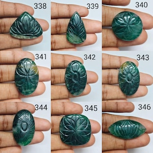 May include: A collection of nine dark green gemstones, each featuring intricate floral carvings. The stones are labeled with numbers 338 through 346, showcasing various shapes including triangular, teardrop, circular, oval, and marquise silhouettes.