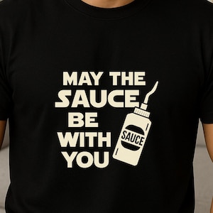 May the Sauce Be With You Shirt – Funny Hot Sauce Lover Gift – Spicy Foodie Graphic Tee – Bold Condiment Humor T-Shirt for Men & Women