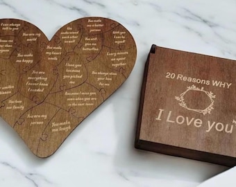 May include: A heart-shaped wooden puzzle with engraved text pieces and a square wooden box. The box lid features the text 20 Reasons WHY I Love you with a floral frame and butterfly icons. The puzzle pieces contain various romantic phrases.