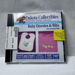 May include: A Dakota Collectibles embroidery design collection CD titled Baby Onesies & Bibs with a 4x4 sewing field. The cover features a squirrel graphic, a white bib with a bowl illustration, and a pink shirt with baby block designs.