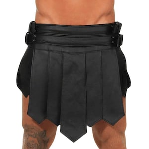 May include: Black leather skirt with a pleated design and a buckled waistband. The skirt has a classic, edgy style.