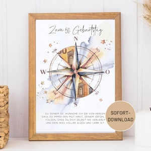 May include: A framed print with a compass rose design, watercolor accents, and the text "Zum 50. Geburtstag." The print includes a message in German and a "SOFORT-DOWNLOAD" sticker. The frame is a warm, light brown color.