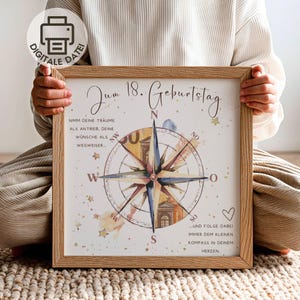 May include: A framed print featuring a compass rose illustration with the German text 'Zum 18. Geburtstag' and inspirational quotes. The design includes gold stars, watercolor accents, and a light wood frame, presented as a digital file.