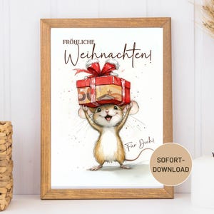 May include: A framed print featuring a cheerful mouse holding a gift box with a red bow. The box has a 50 Euro bill on top. The words "Fröhliche Weihnachten!" are written above the mouse, and "Für Dich!" below. A circular "SOFORT-DOWNLOAD" label is in the bottom right.
