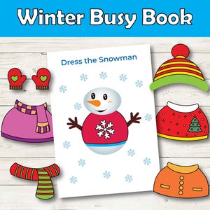 May include: A "Winter Busy Book" with a "Dress the Snowman" activity. The image features a snowman illustration with various winter clothing cutouts, including a hat, sweater, mittens, scarf, and skirt. The background is a light wood grain.